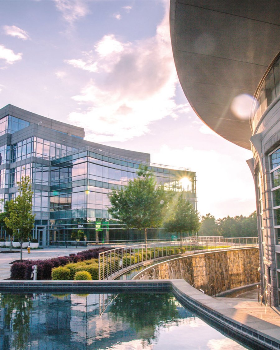 Corporate office campus with landscaped plaza and water feature